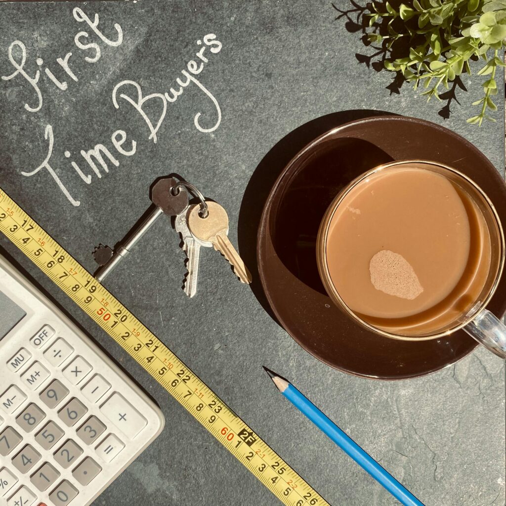 Flat lay of keys, calculator, and coffee, perfect for first-time homebuyers concept.